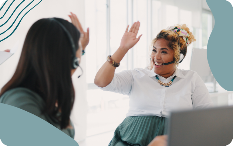 Two employees high-fiving